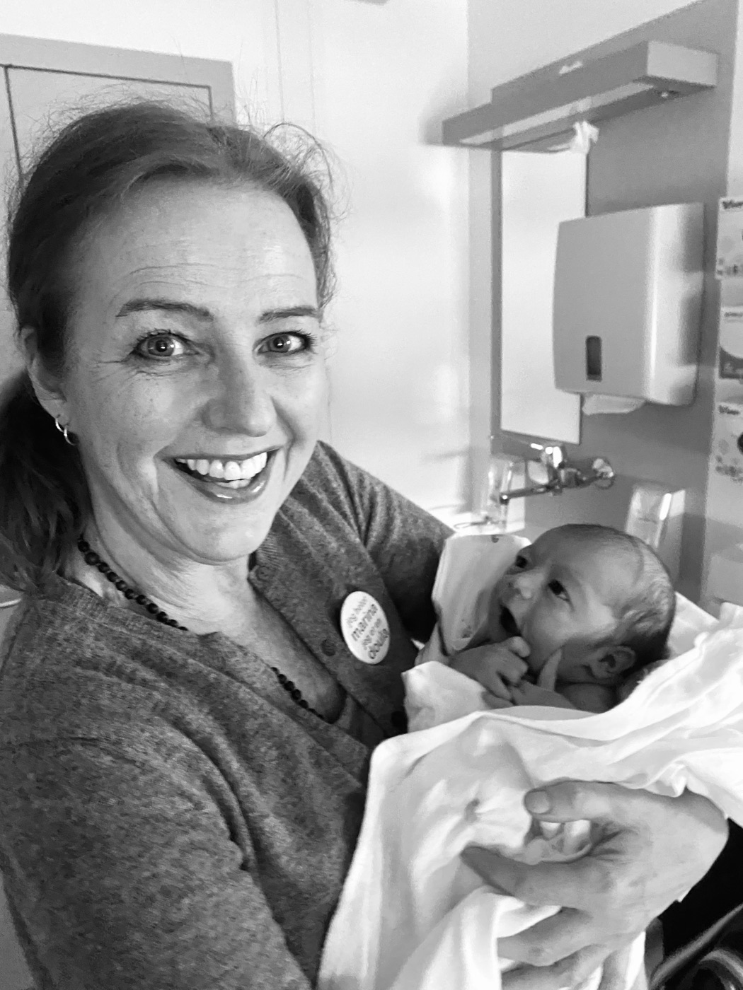 Marina smiler med en nyfødt baby i armene på sykehuset